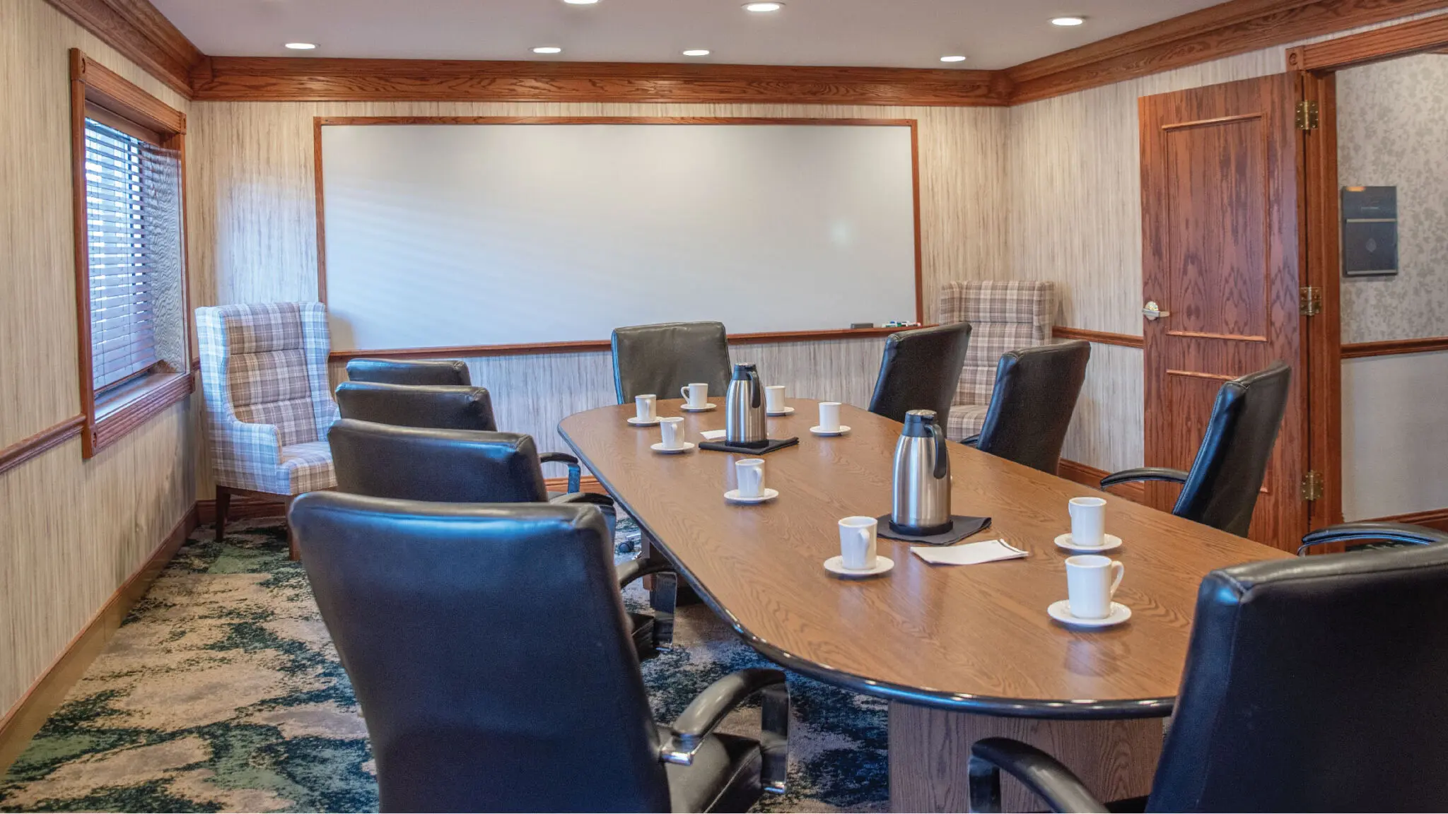 Lapham Boardroom set up with coffee mugs and a white board.