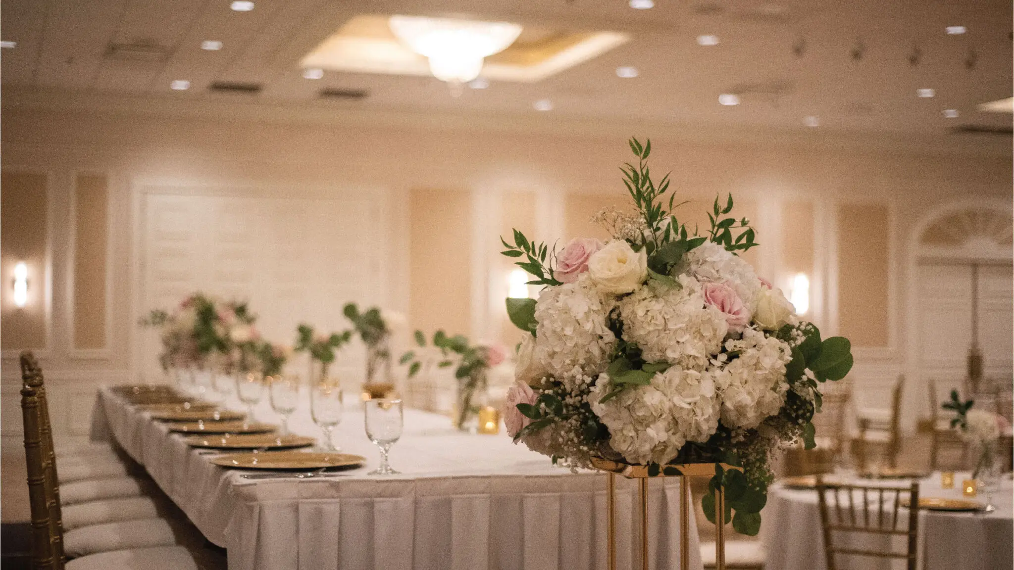 Close up of wedding flowers and head tablescape in Oakton Ballroom.