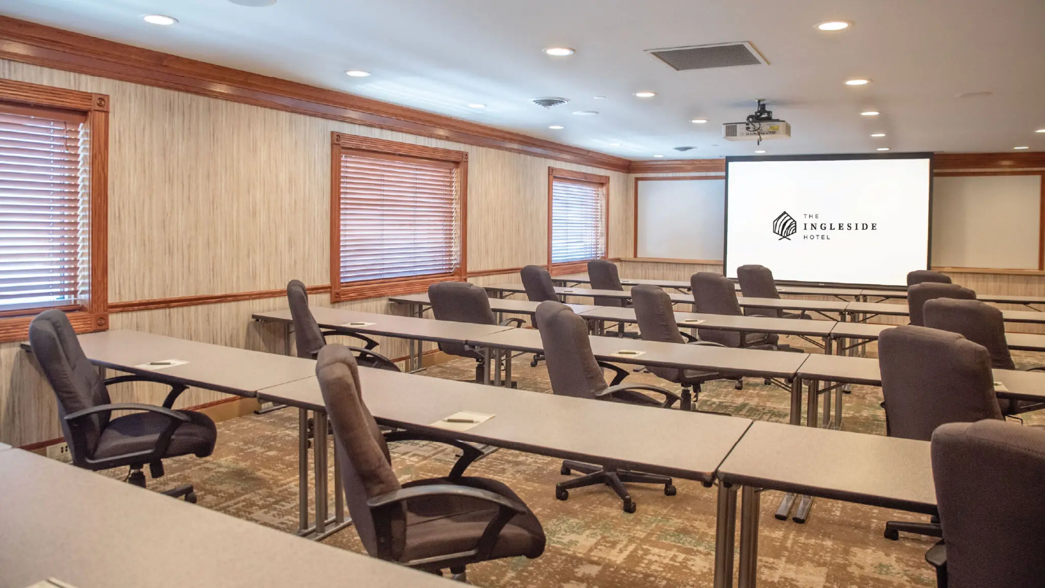 Lapham meeting room set up classroom style with a screen projector.