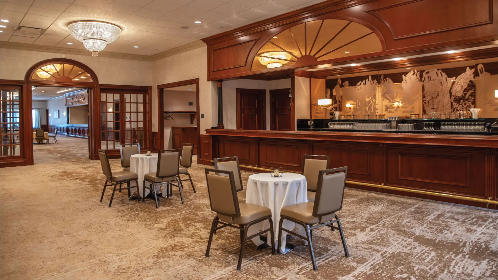 Lake Country Foyer with cocktail tables and a built in bar.