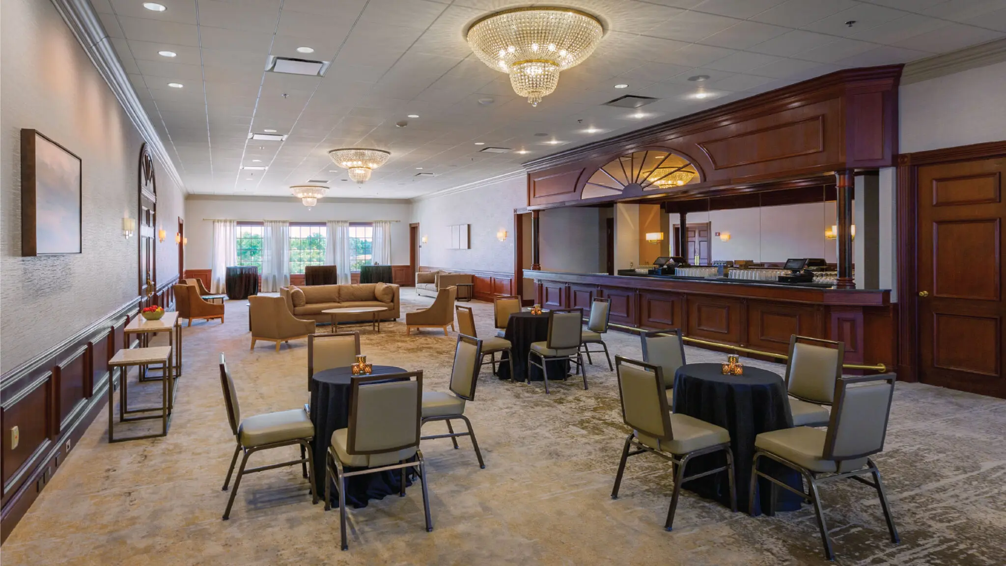 Oakton Ballroom Foyer with soft seating, cocktail tables, and a built in bar.