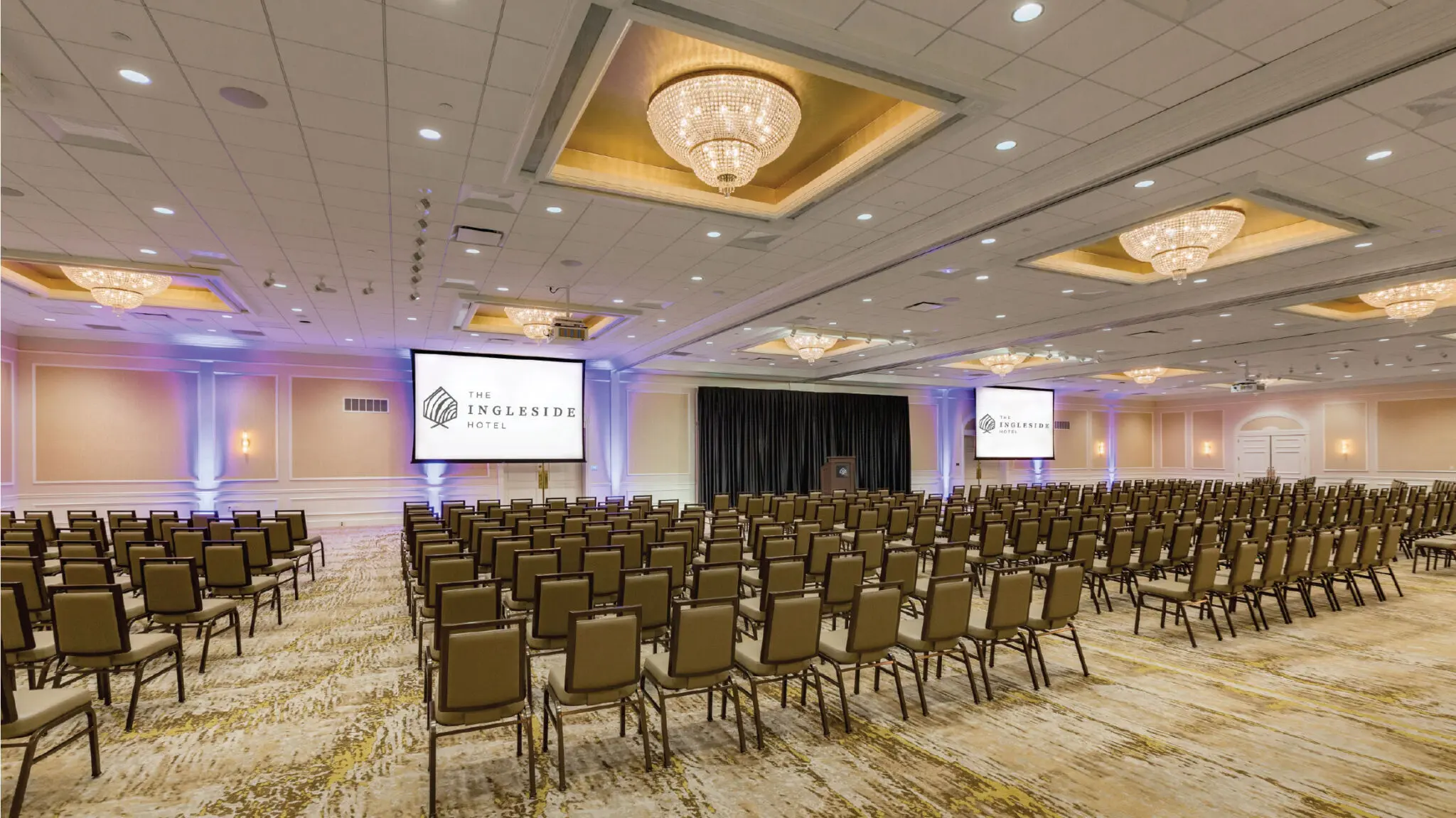 Lake Country Ballroom set up with rows of chairs and two projector secreens.