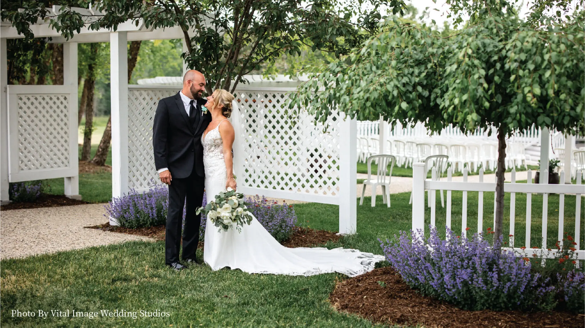 Wedding couple posing outside under white terrace.